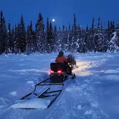 Winter snowmobile ride through snowy trails